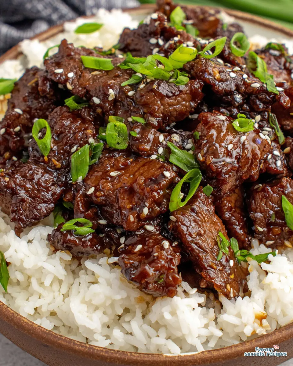 Close up of sticky teriyaki sauce coating beef strips